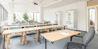 An empty classroom with lots of natural light.